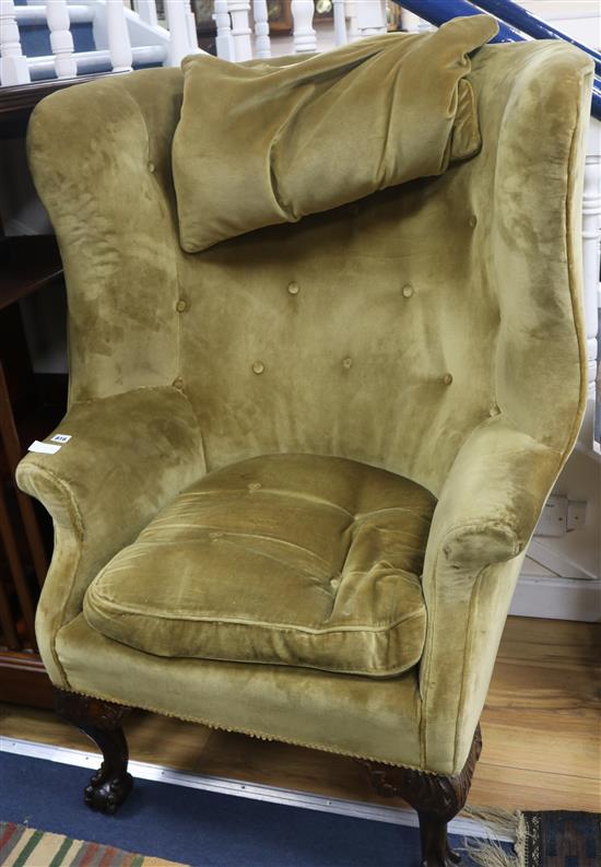 A barrel back button back upholstered chair